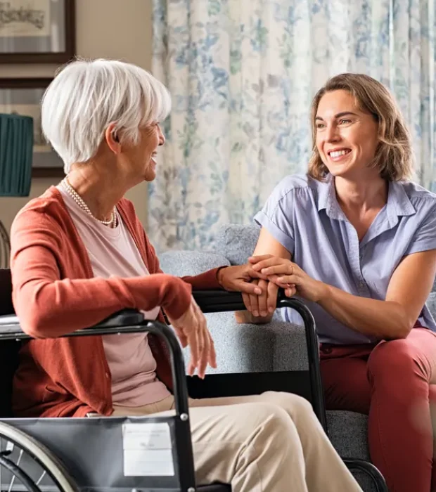 A caregiver and elderly woman in wheelchair, highlighting aged care pest control solutions for a safe, comfortable home.