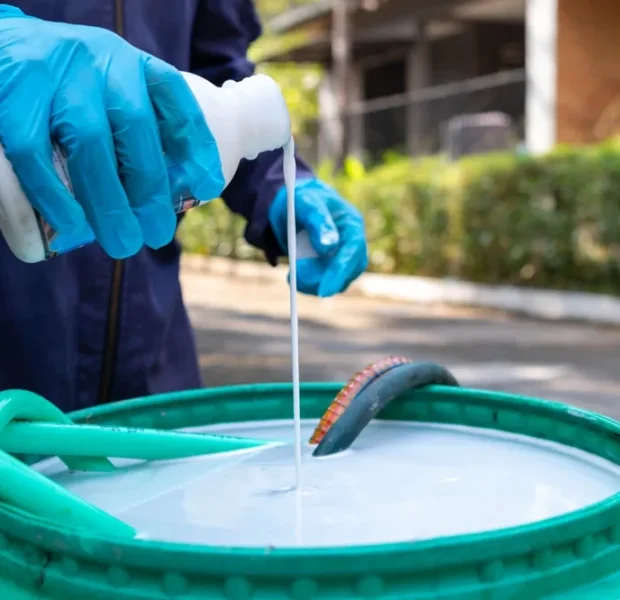 Expert preparing industrial pest solutions treatment for commercial application