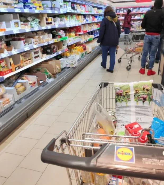 Shoppers with carts in a supermarket aisle highlighting the importance of supermarket pest removal