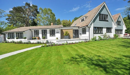 Fresh green lawn outside home protected through residential pest control services